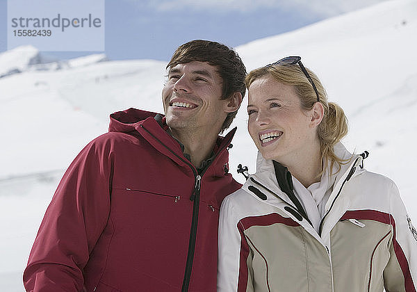 Österreich  Tirol  Junges Paar schaut weg  lächelt