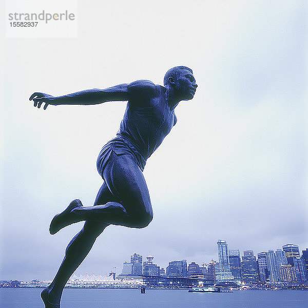 Kanada  Britisch-Kolumbien  Vancouver  Stanley Park  Statue von Harry Jerome mit der Stadt im Hintergrund