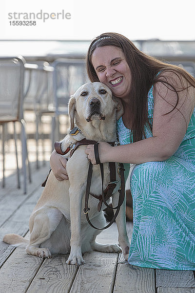 Blinde Frau umarmt ihren Diensthund