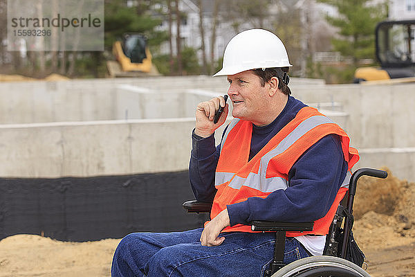 Querschnittsgelähmter Bauingenieur im Radio auf der Baustelle