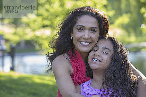 Porträt einer glücklichen hispanischen Frau und ihrer jugendlichen Tochter mit Zahnspange