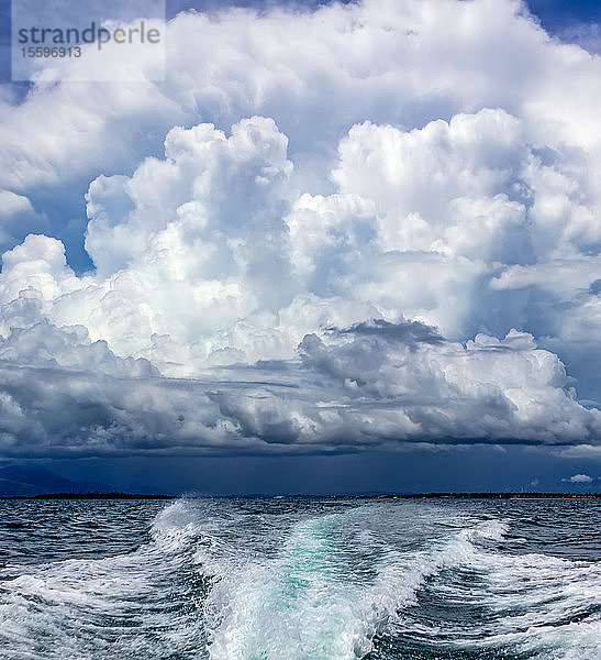 Wake from a boat in the ocean with dramatic storm clouds; Malolo Island  Fiji