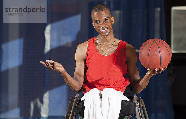 Mann mit Spinaler Meningitis im Rollstuhl hält Basketball