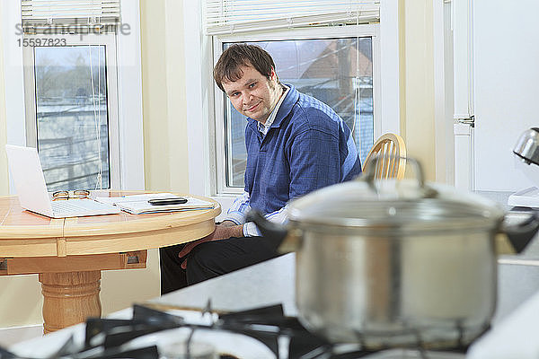 Mann mit Asperger-Syndrom arbeitet beim Kochen in seinem Haus