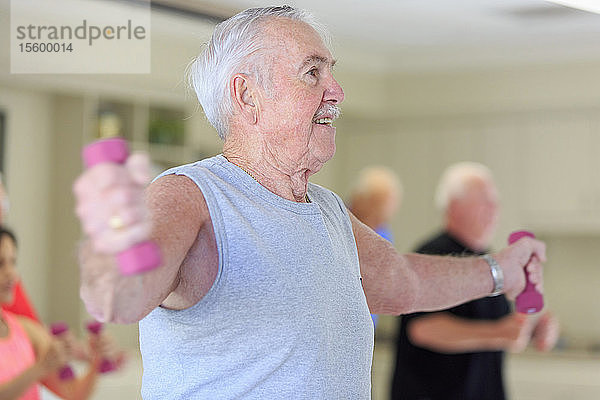 Glücklicher älterer Mann beim Training im Fitnessstudio
