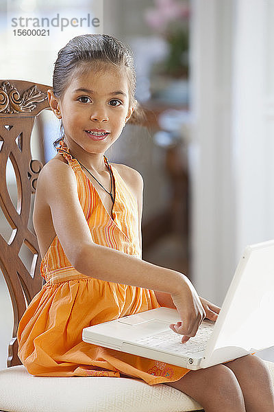 Porträt eines hispanischen Mädchens  das an einem Laptop arbeitet
