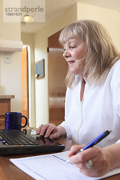 Frau mit bipolarer Störung arbeitet von zu Hause aus an ihrem Laptop