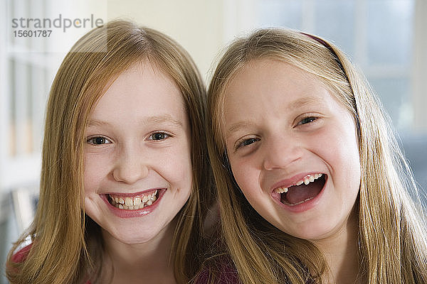 Porträt von zwei lachenden Schwestern.