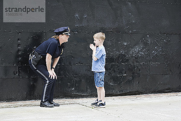 Polizeibeamtin im Gespräch mit einem Jungen.