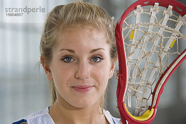 Porträt einer Frau mit einem Lacrosse-Schläger.