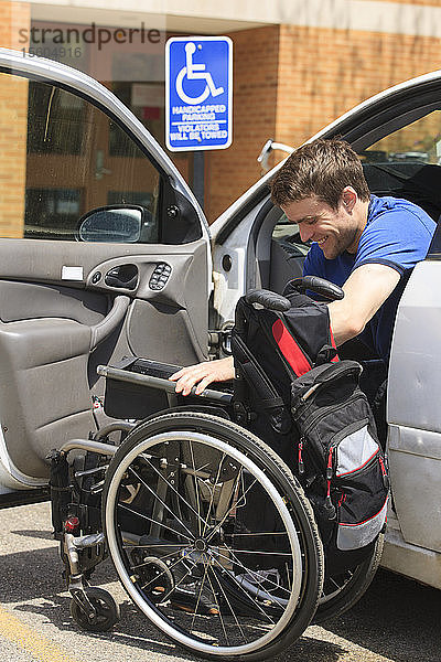 Mann mit Rückenmarksverletzung setzt seinen Rollstuhl in sein Auto
