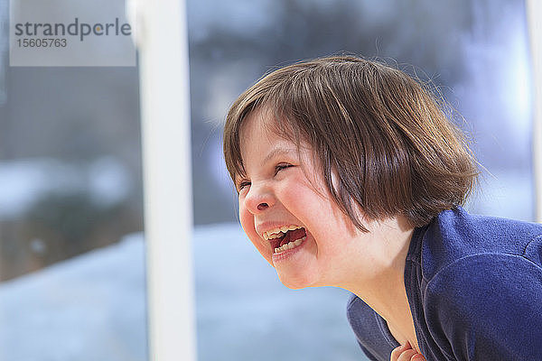 Kleines Mädchen mit Down-Syndrom lacht
