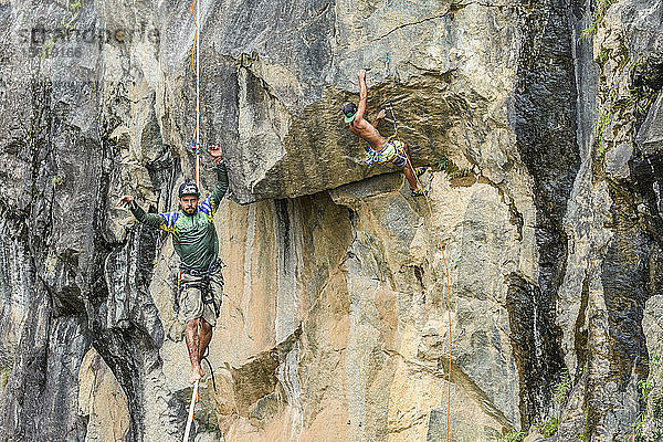 Foto von abenteuerlustigen Männern  von denen einer klettert und der andere slacklined  Steinbruch Dibs  Maripora  Staat Sao Paulo  Brasilien