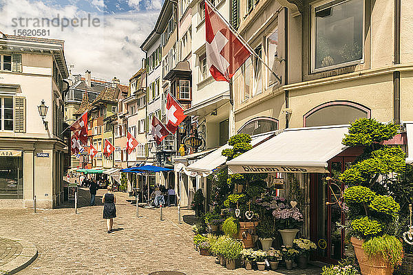 Malerische Altstadtstraße mit Wohnhäusern und Fahnen  Zürich  Schweiz