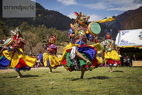 Farbenfrohe  traditionell maskierte tibetische Cham-Tänzer beim Nomadenfest in Bhutan