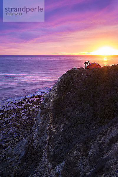 Zeltaufbau bei Sonnenuntergang auf den Klippen über dem Meer an der Küste von Mittelkalifornien