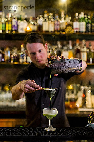 Ein Barkeeper macht einen ausgefallenen Cocktail in einer protzigen Bar in Seattles Capital Hill-Viertel.