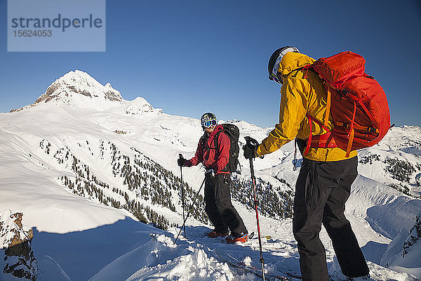 Zwei Skifahrer auf dem Gipfel eines Berges in der Nähe der Elfin Lakes im Garibaldi Provincial Park  Kanada