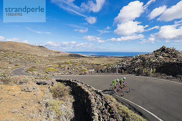 Zwei Rennradfahrer fahren nebeneinander auf der Straße  Lanzarote  Kanarische Inseln  Spanien