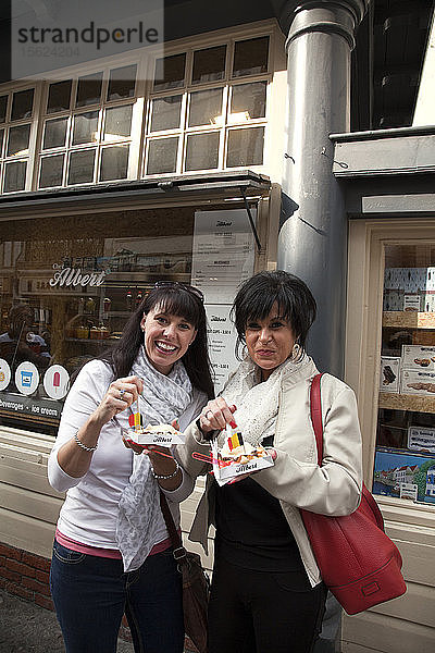 Was wäre der logische Snack in Brügge? Belgische Waffeln  natürlich. Dawna Miller (links) und ihre Mutter  Wanda Lawless  können nicht widerstehen  einen der traditionellen Snacks zu probieren.