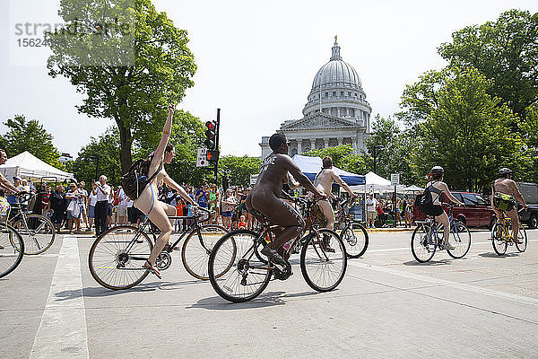 Eine große Anzahl nackter Radfahrer fährt am State Capitol vorbei  um gegen die Abhängigkeit von fossilen Brennstoffen zu protestieren  Madison  Wisconsin  USA