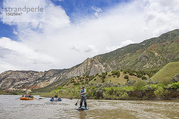 Mann Standup Paddleboarding In Green River  Utah  Usa