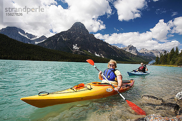 Ein kanadisches Paar fährt Kajak auf dem Waterfowl Lake in den kanadischen Rockies.