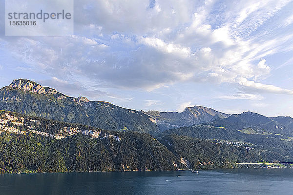 Schweiz  Gersau  Schwyz  Blick auf Wolken über dem Vierwaldstättersee und hohe bewaldete Klippen im Sommer
