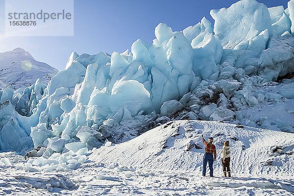 Wanderer am Rande des zugefrorenen Portage Lake und Blick auf das Eis des Portage Glacier  Süd-Zentral-Alaska und südlich von Anchorage; Alaska  Vereinigte Staaten von Amerika