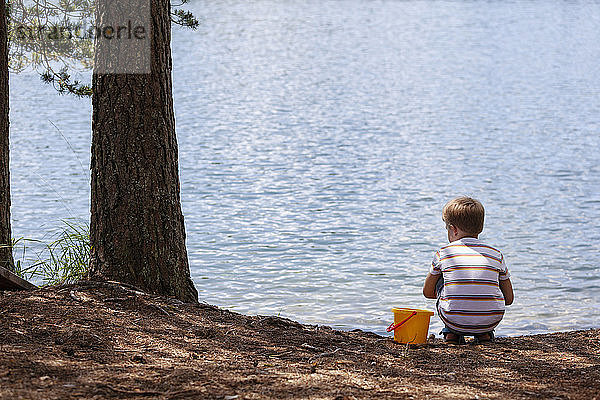 Junge spielt am See