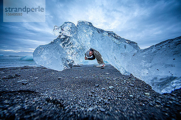 Mann erkundet Eisformationen  Diamond Beach  Island