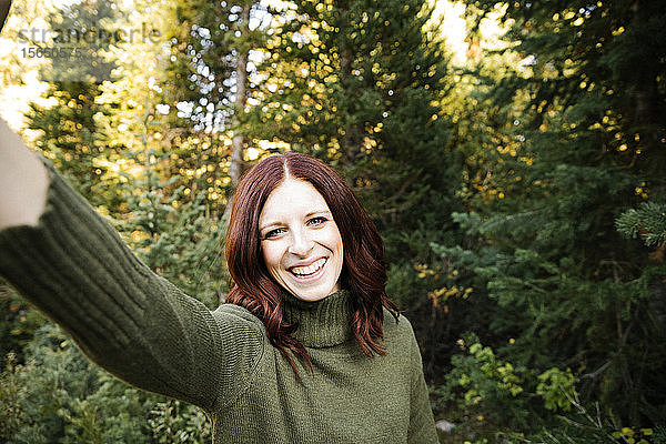 Frau nimmt Selfie im Wald