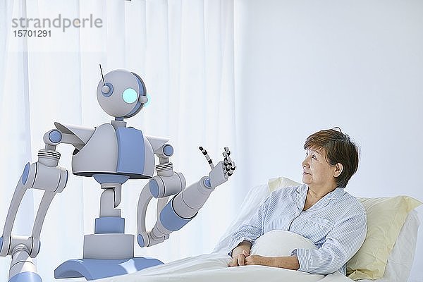 Ältere Japanerin mit Roboter