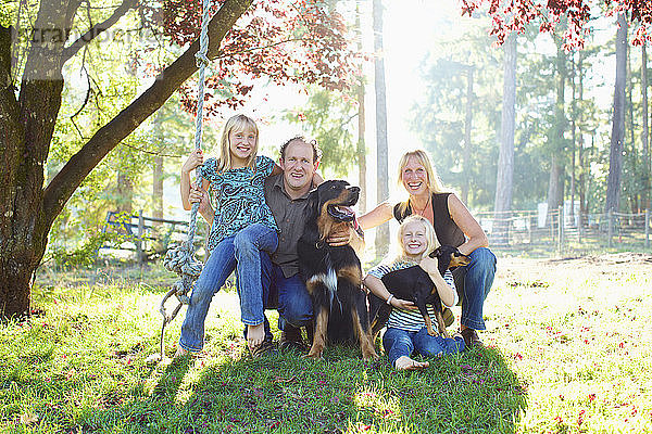 Porträt glückliche Familie mit Hunden im sonnigen Herbst Park