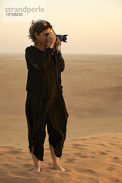 Frau beim Fotografieren in der Wüste  Düne 7  Walvis Bay  Namibia