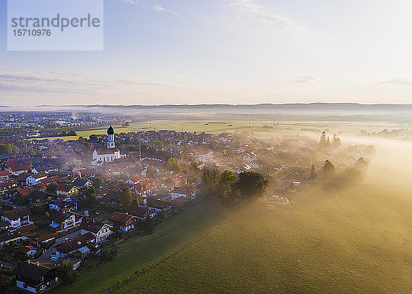 Deutschland  Bayern  Geretsried  Luftaufnahme einer vom Morgennebel umhüllten Landstadt