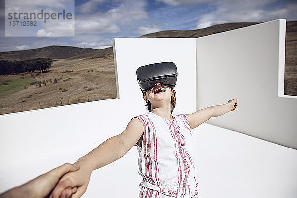 Mädchen schaut durch eine VR-Brille im offenen Raum