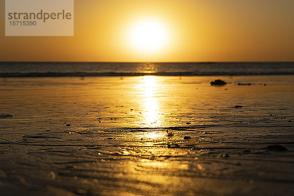 USA  Kalifornien  Santa Monica  Die untergehende Sonne beleuchtet den feuchten Sand des Küstenstrandes