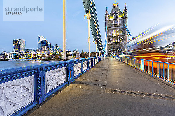 Großbritannien  England  London  verschwommene Bewegung eines Doppeldeckerbusses  der im Morgengrauen über die Tower Bridge fährt