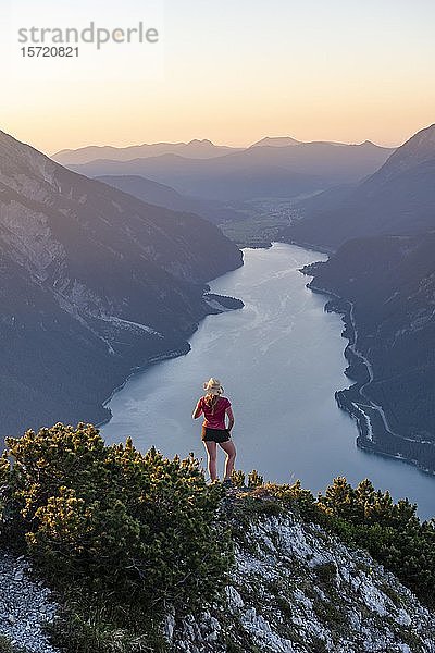 Sonnenuntergang  junge Frau blickt über Berglandschaft  Blick vom Bärenkopf zum Achensee  Tirol  Österreich  Europa