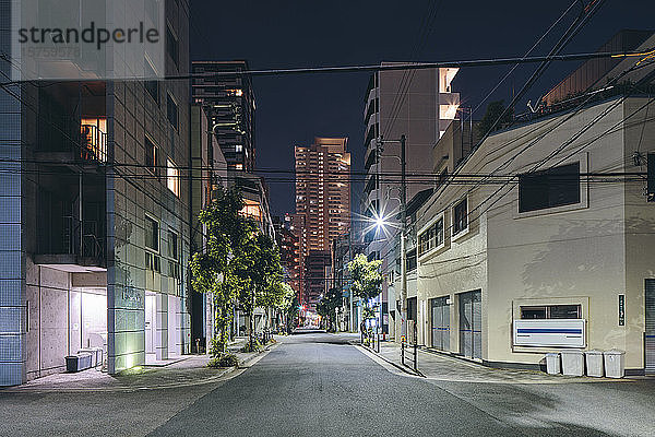 Nächtliche Szene mit Apartmenthäusern in der Innenstadt  Einzelhandelsgebäuden und modernen Bürogebäuden in der Ferne  Osaka  Japan