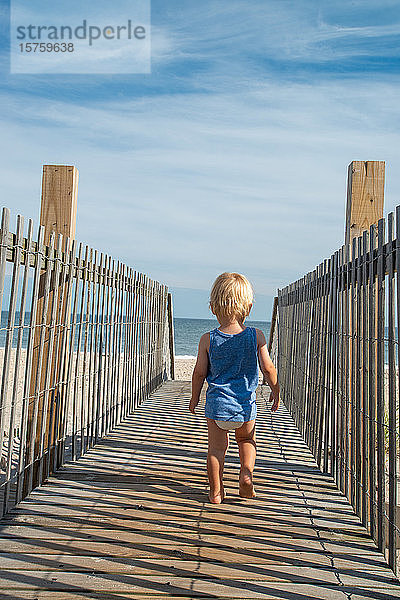 Kleinkind beim Strandspaziergang an der Strandpromenade