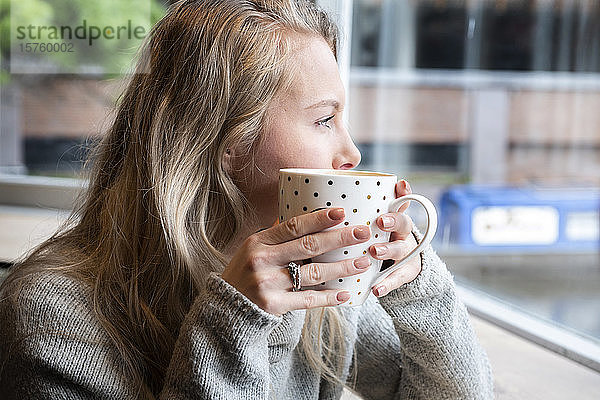 Frau beim Tee im Café