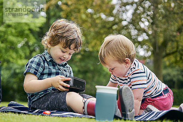 Brüder teilen Essen im Park