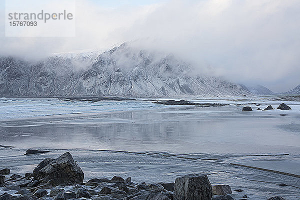 Majestätischer schneebedeckter Berg hinter dem Meer Skagsanden Lofoten Norwegen