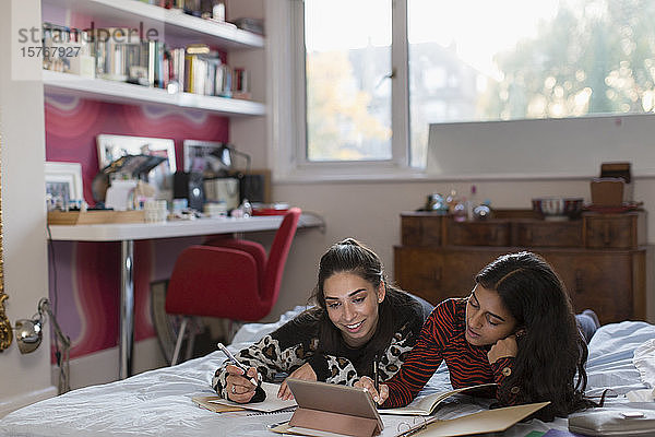 Teenager-Mädchen Freunde studieren tun Hausaufgaben auf dem Bett