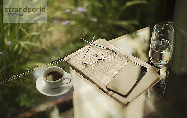 Smartphone und Börsenzeitung auf Tisch mit Kaffee