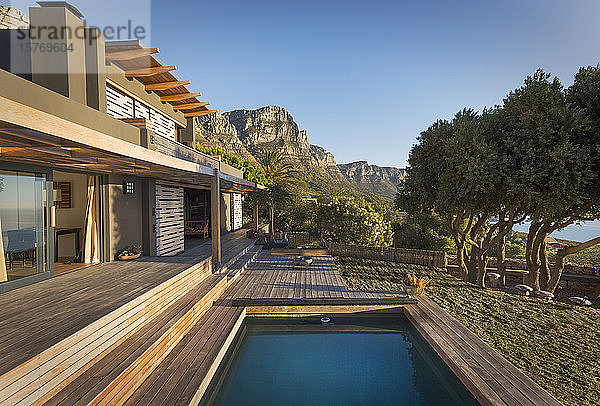Berge im Hintergrund eines luxuriösen Musterhauses mit Swimmingpool