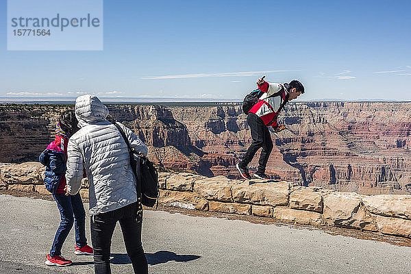 Touristen  die so tun  als würden sie vom Mohave Point in den Grand Canyon fallen  South Rim; Arizona  Vereinigte Staaten von Amerika