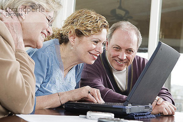 Blick von Freunden auf einen Laptop.
